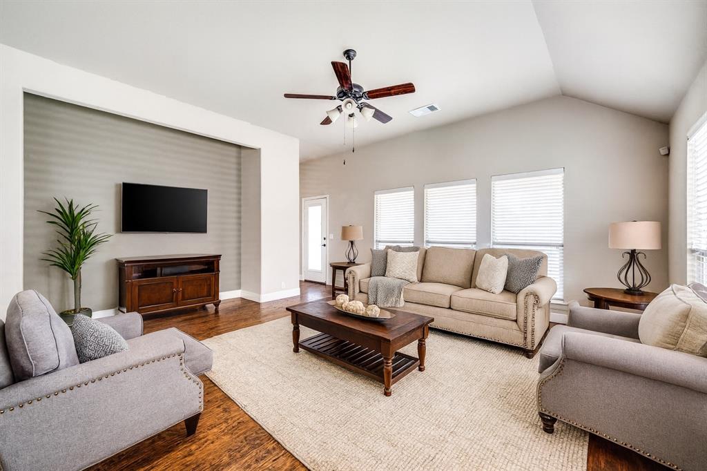 817 Lighthouse Lane Savannah, TX 76227 - Photo 4 of 20 a living room with furniture a fireplace and a flat screen tv