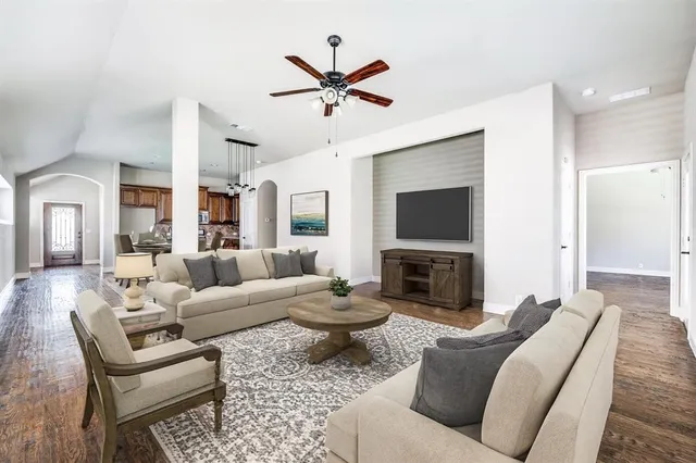 a living room with fireplace furniture and a flat screen tv