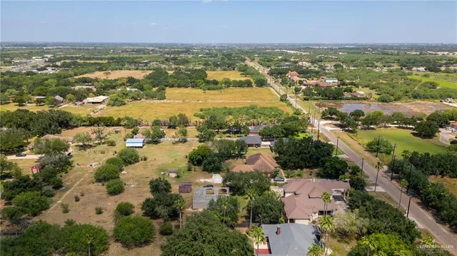 an aerial view of residential houses with outdoor space and river