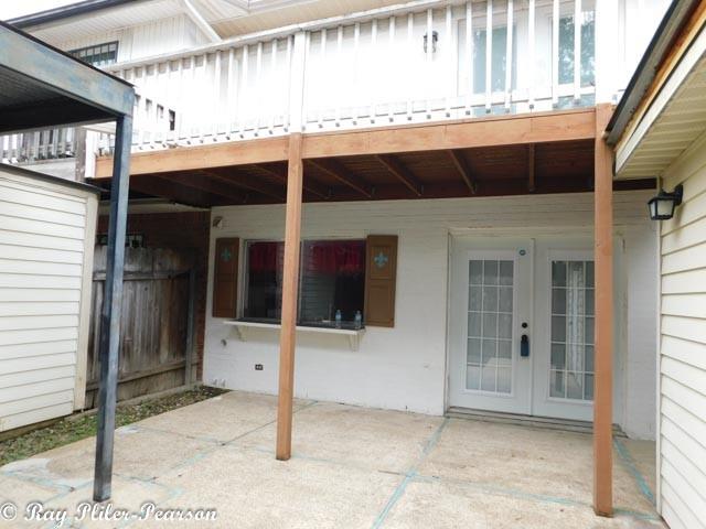 8020 Pines Road Shreveport, LA 71129 - Photo 21 of 24 View of patio area as you come into gate with private deck above off one of the primary bedrooms.