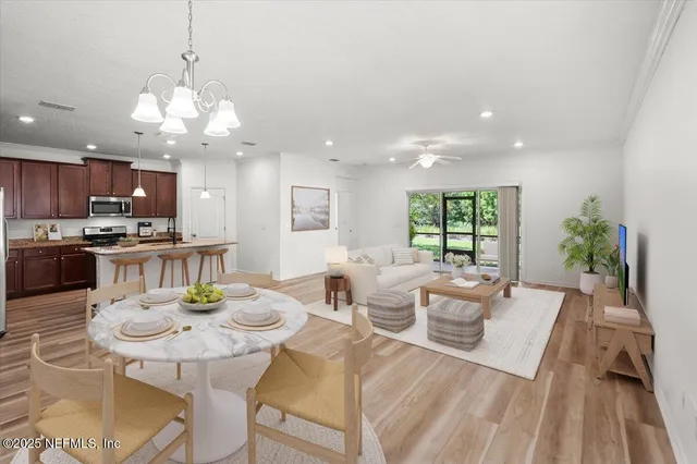 a view of a kitchen with a sink and dishwasher a refrigerator with wooden floor