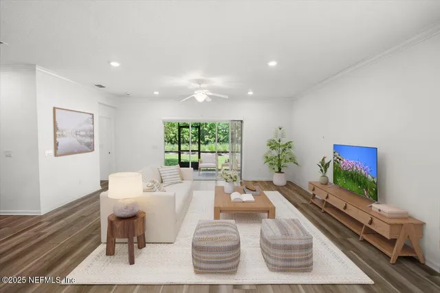 a living room with furniture kitchen view and a chandelier