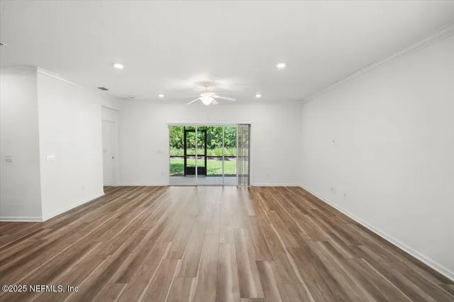 a kitchen with stainless steel appliances granite countertop a table chairs refrigerator and microwave