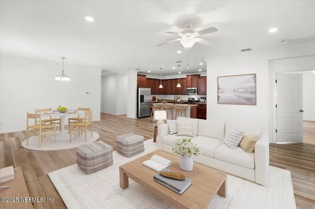 a large kitchen with a center island stainless steel appliances and a counter top space