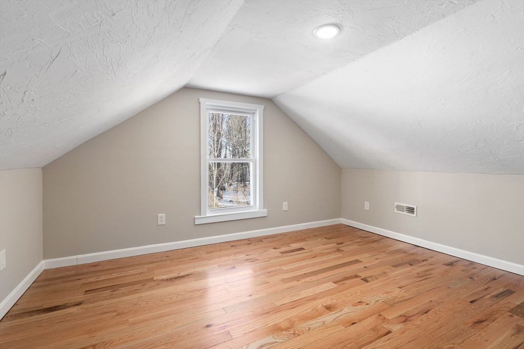 39 Highland Park Road Rutland, MA 01543 - Photo 12 of 30 an empty room with wooden floor and windows