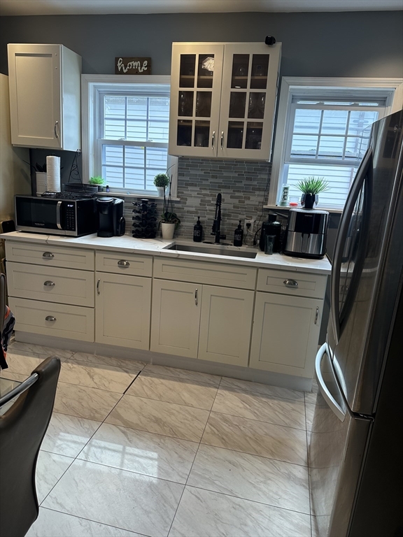 58 Walnut Street Everett, MA 02149 - Photo 8 of 15 a kitchen with a sink window and cabinets