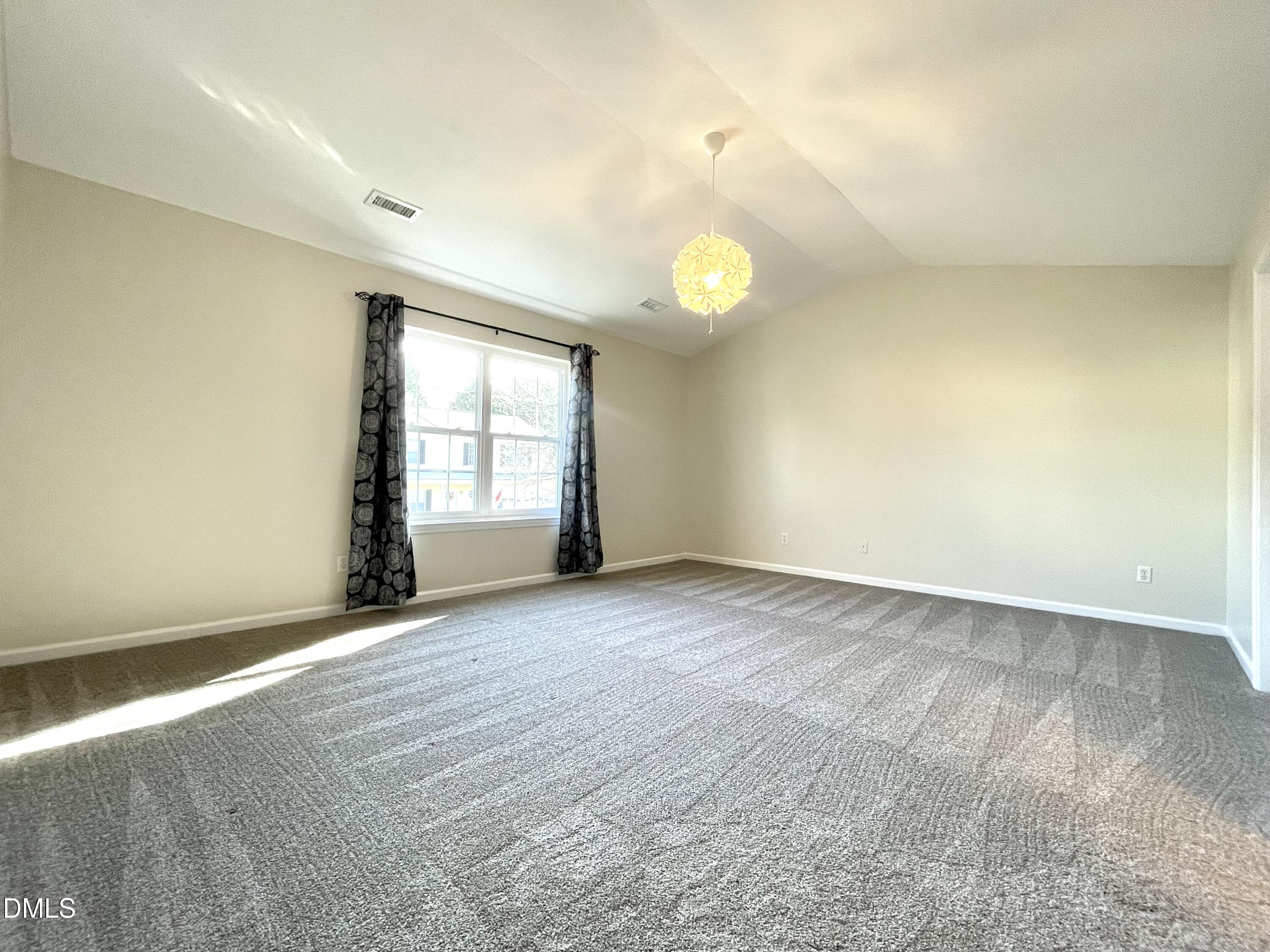 5506 Grand Mesa Drive Durham, NC 27713 - Photo 17 of 28 a view of an empty room with a window
