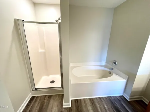 a bathroom with a tub and shower