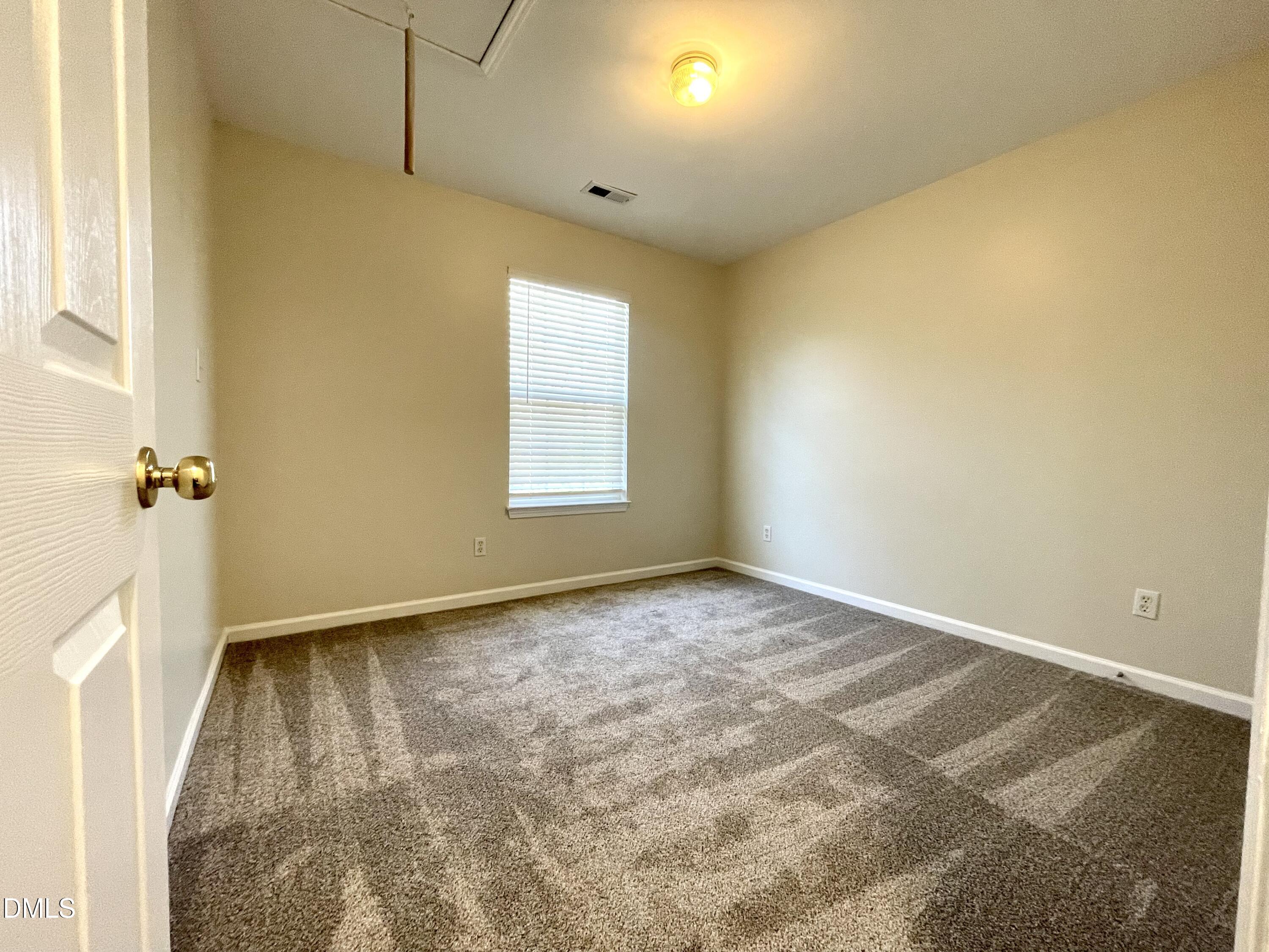 5506 Grand Mesa Drive Durham, NC 27713 - Photo 20 of 28 an empty room with a window