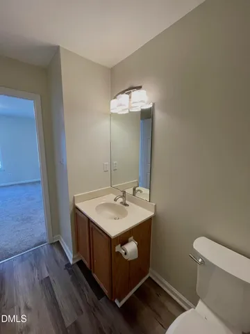 a bathroom with a sink toilet and mirror