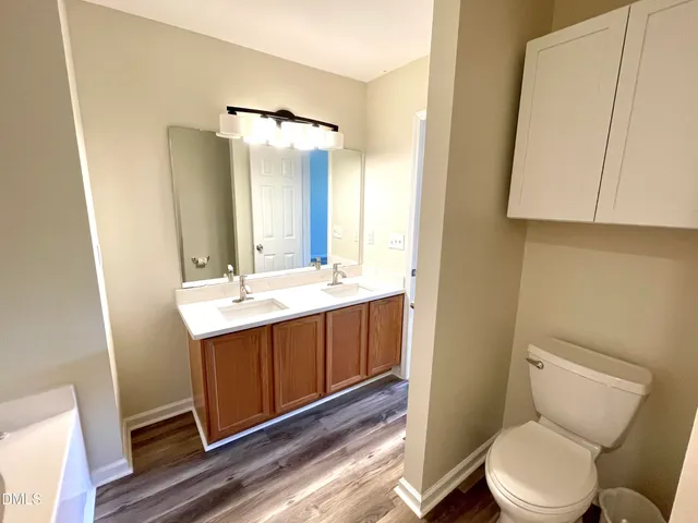 a bathroom with a sink mirror vanity and toilet