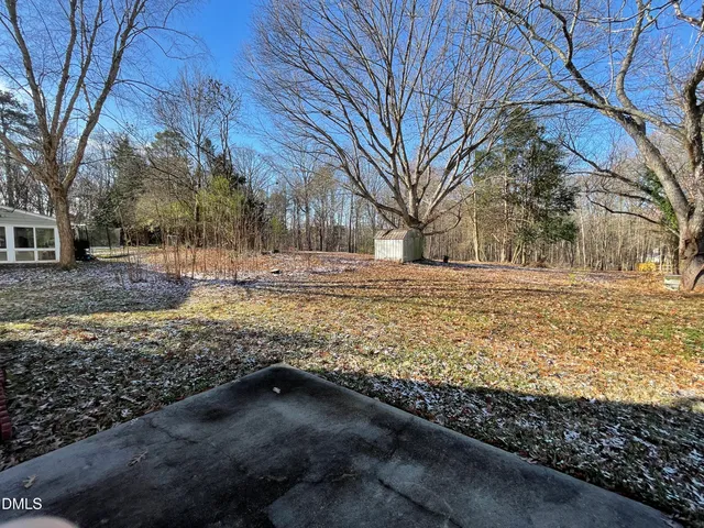 a view of yard covered with snow in front of house