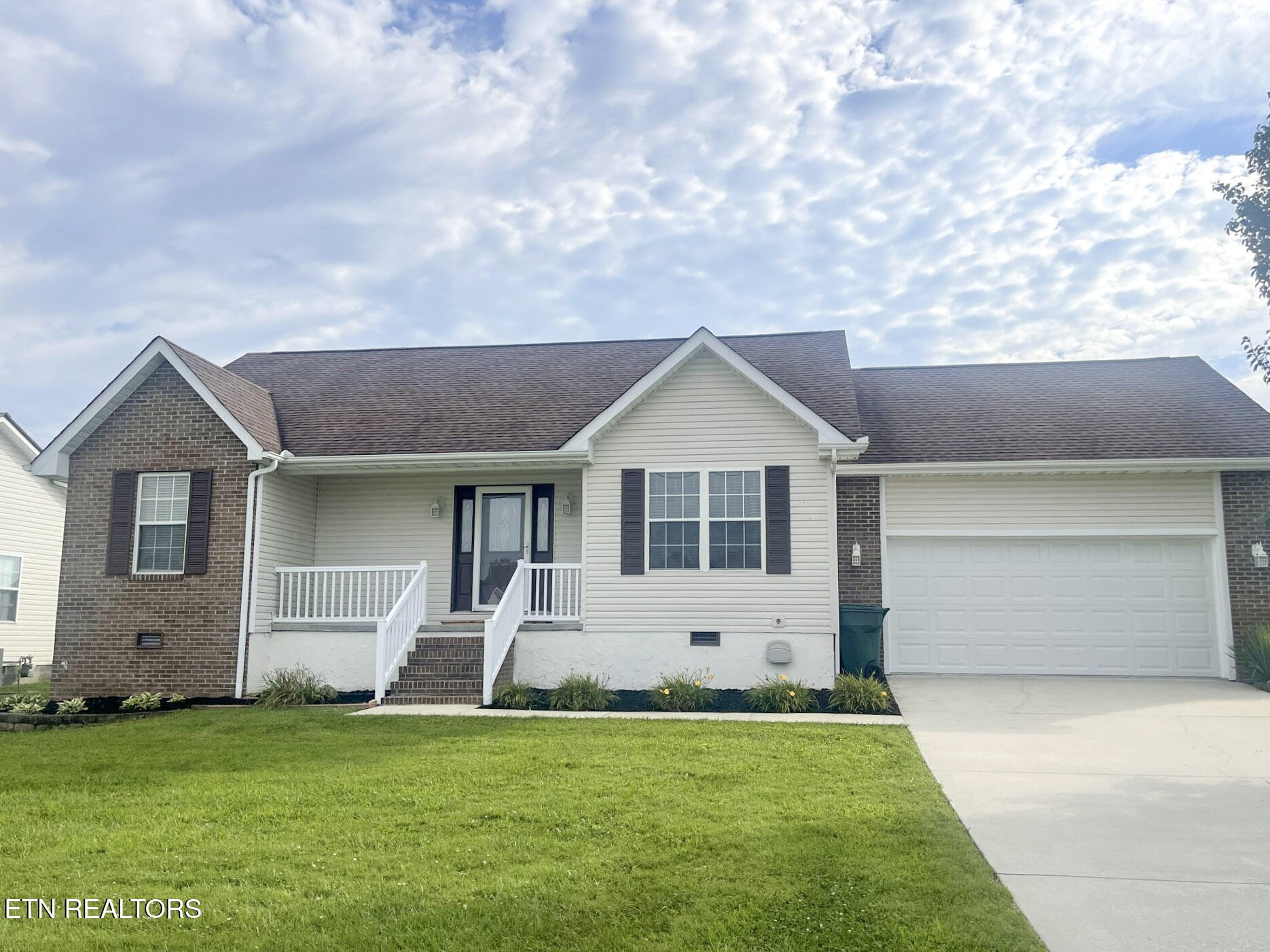 299 Jesse Loop Crossville, TN 38555 - Photo 3 of 32 a front view of a house with a yard