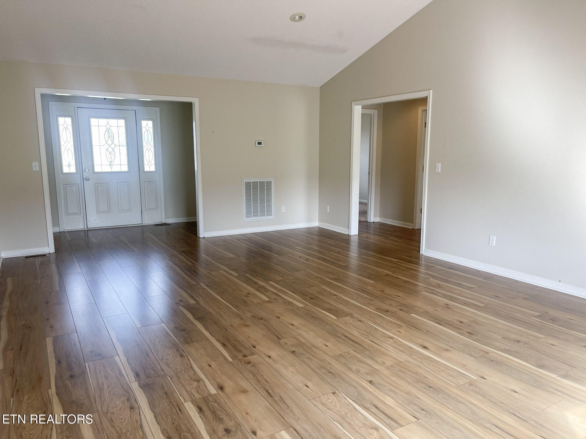 299 Jesse Loop Crossville, TN 38555 - Photo 7 of 32 a view of an empty room with wooden floor and a window