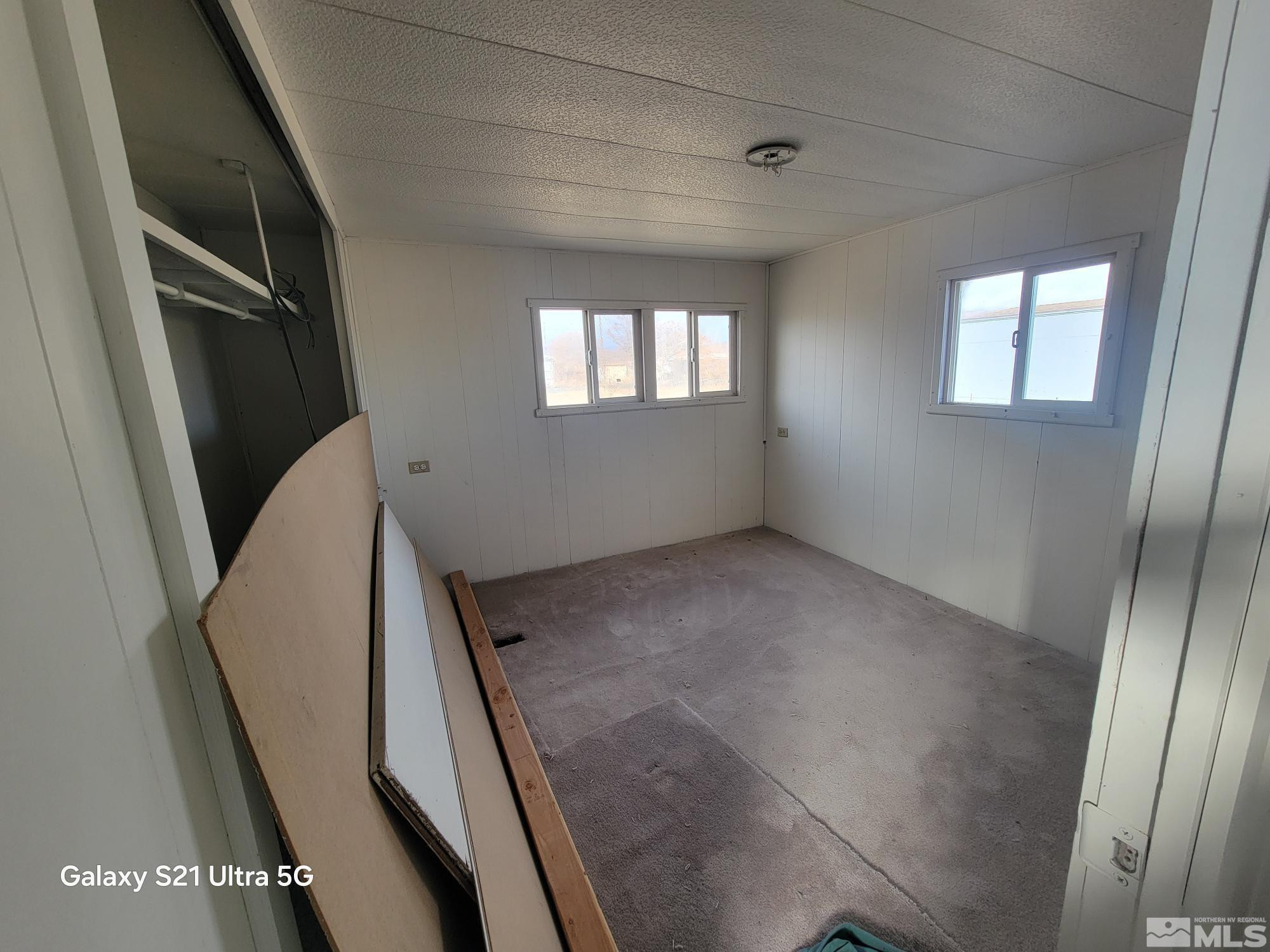 3205 Citrus Street Silver Springs, NV 89429 - Photo 5 of 15 a view of an empty room with wooden floor and a window
