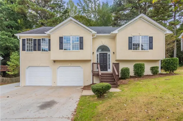 a front view of a house with a yard and garage