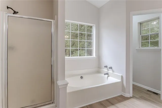 a bathroom with a bathtub and shower