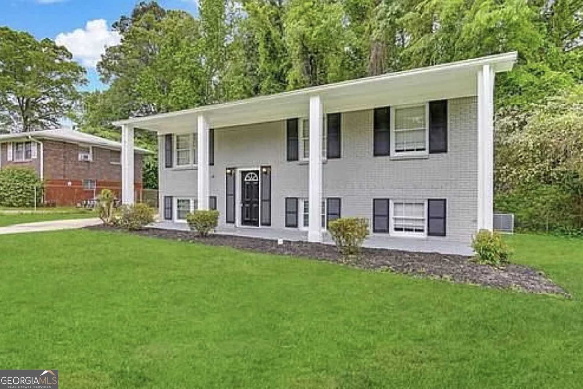 2782 Ocean Valley Road Atlanta, GA 30349 - Photo 1 of 27 a front view of a house with a garden and yard