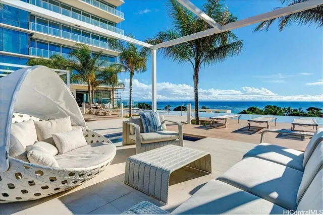 a living room with patio furniture and a potted plant