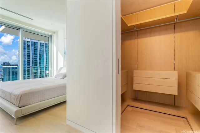 a bedroom with a bed and cabinet