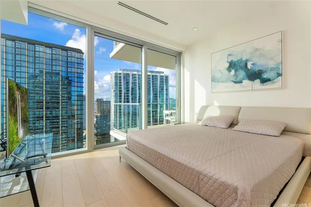 a bedroom with a large bed and a large window