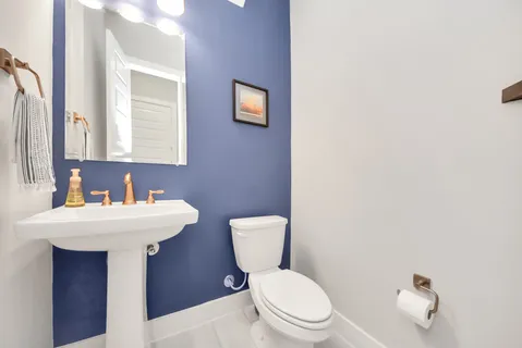 a white toilet sitting next to a bathroom sink