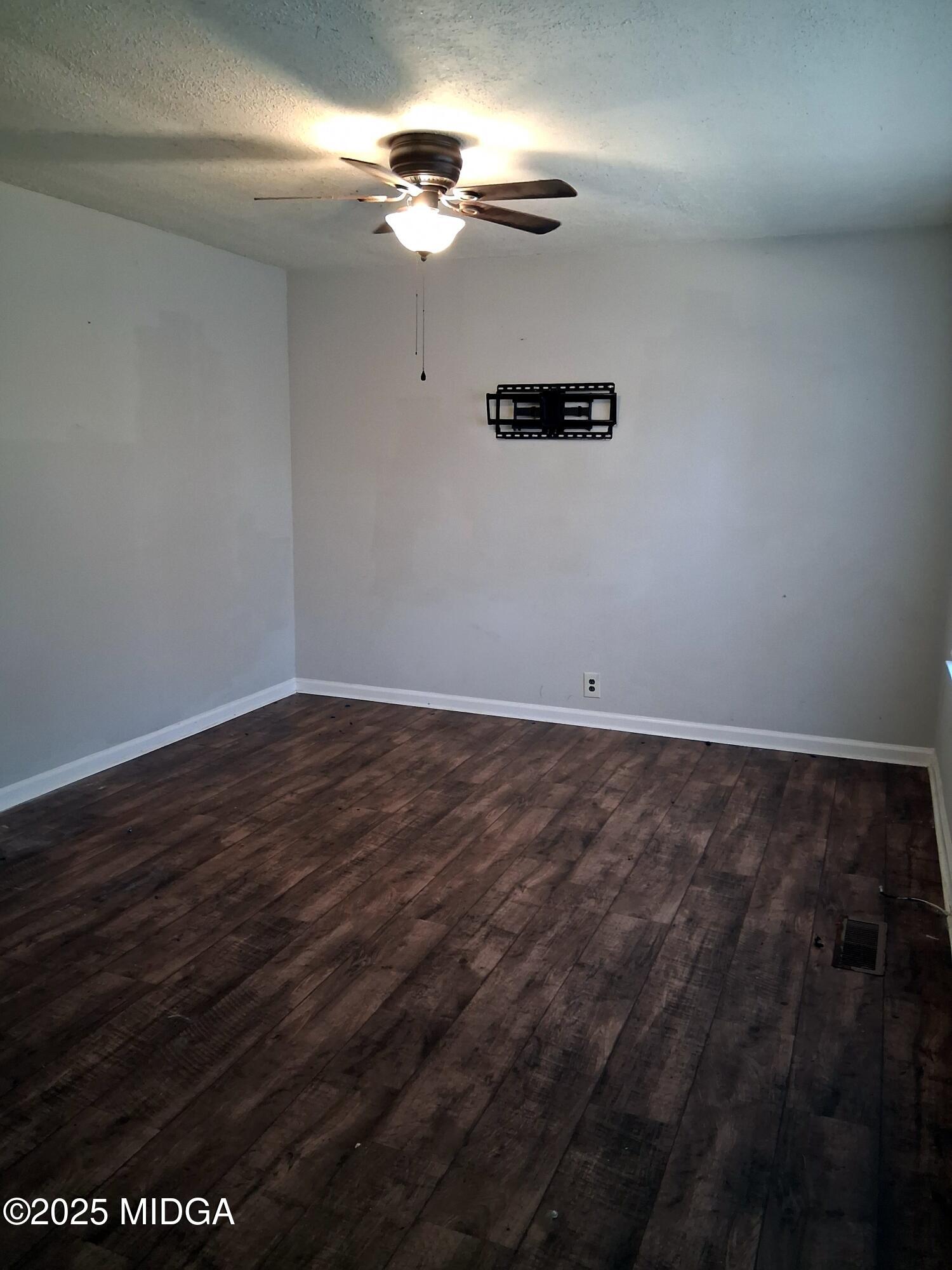 1464 Williamson Road Macon, GA 31206 - Photo 3 of 9 a view of a room with hardwood floor and a ceiling fan