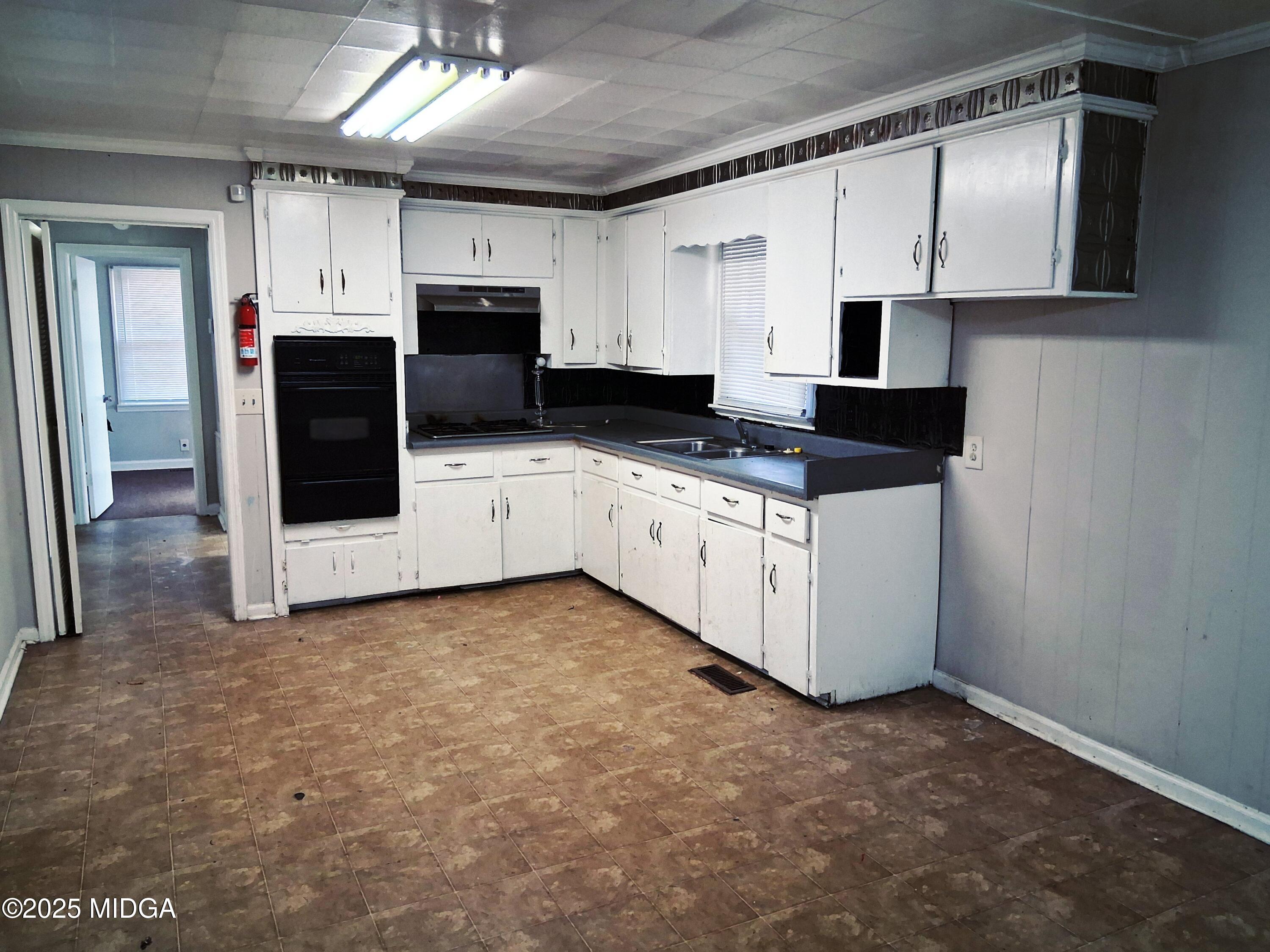 1464 Williamson Road Macon, GA 31206 - Photo 5 of 9 a kitchen with stainless steel appliances a sink and a refrigerator