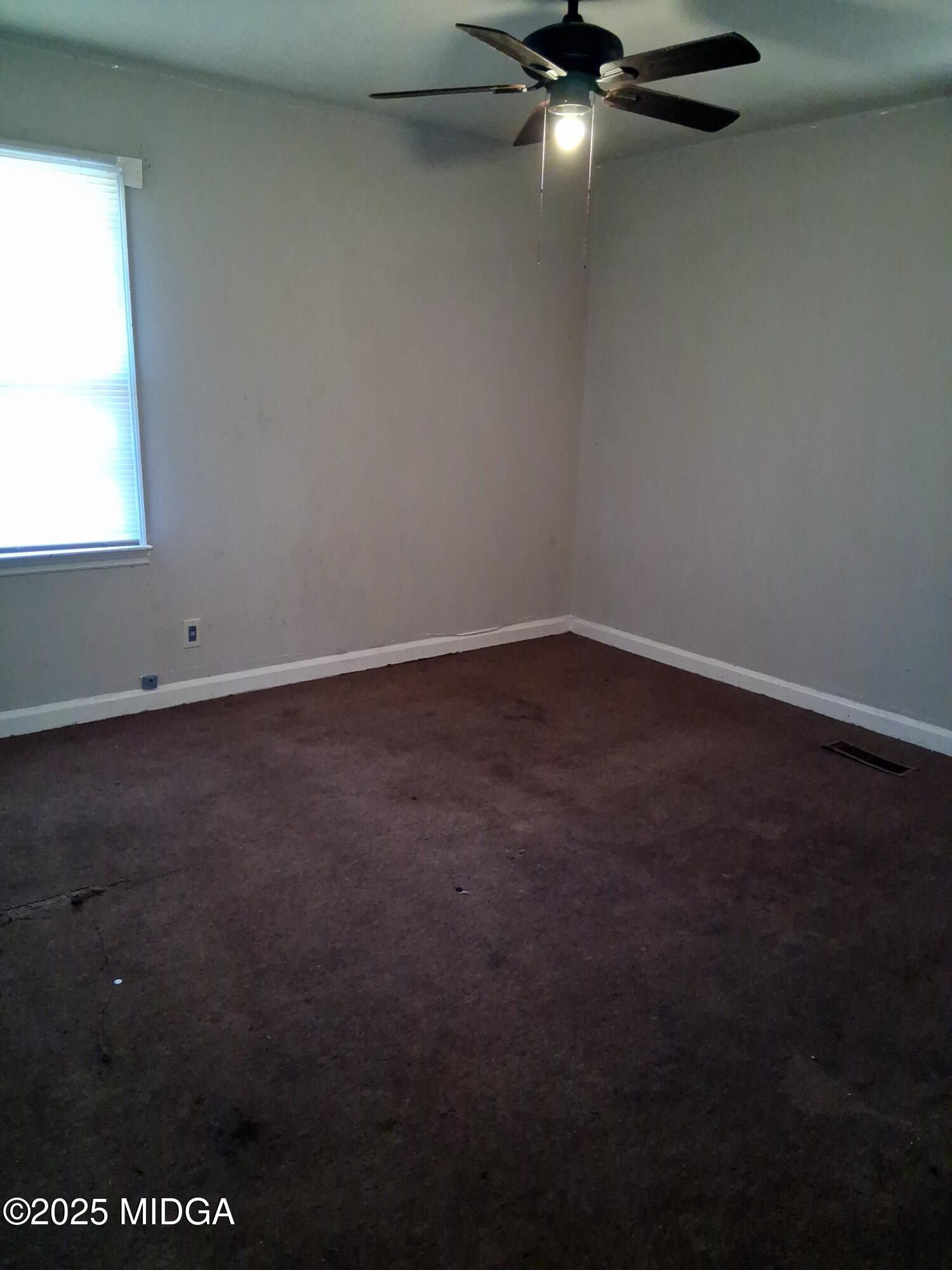 1464 Williamson Road Macon, GA 31206 - Photo 6 of 9 an empty room with a window
