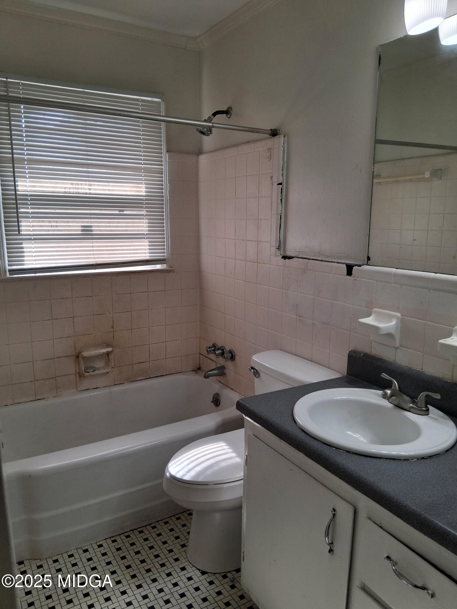 1464 Williamson Road Macon, GA 31206 - Photo 7 of 9 a bathroom with a sink toilet and shower