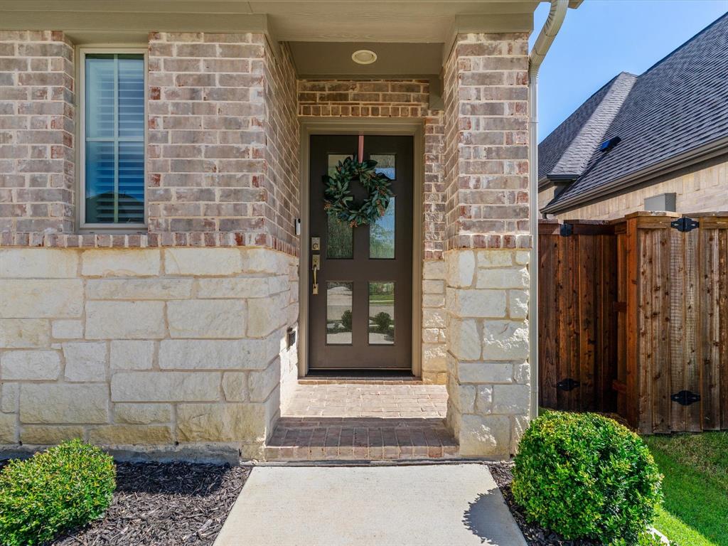 166 Palo Duro Bend Rhome, TX 76078 - Photo 4 of 40 Welcoming front entry with modern design elements and covered porch.