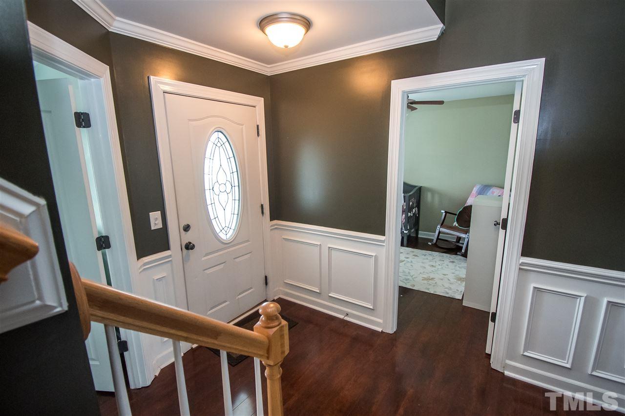 4813 Kure Road Raleigh, NC 27603 - Photo 3 of 25 a view of a hallway with wooden floor and stairs