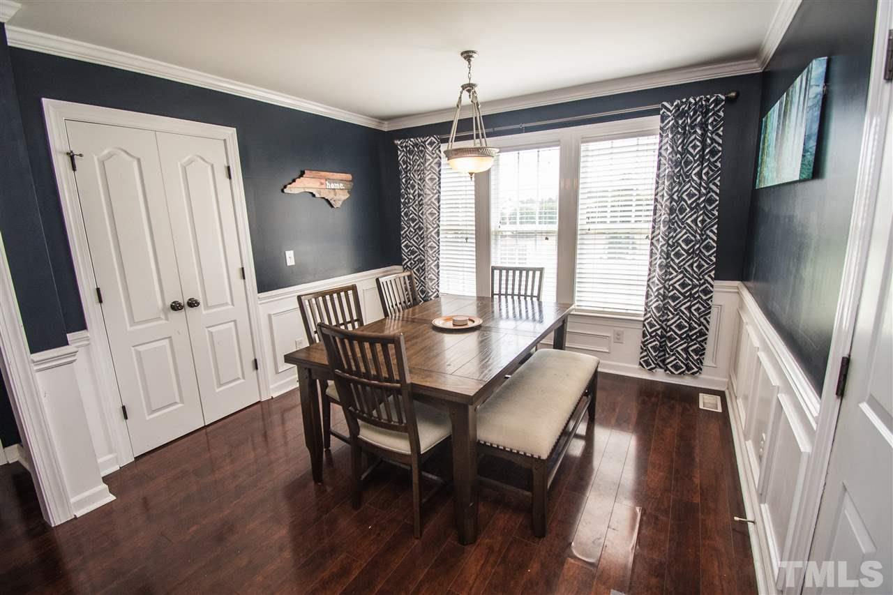4813 Kure Road Raleigh, NC 27603 - Photo 4 of 25 a view of a dining room with furniture window and wooden floor
