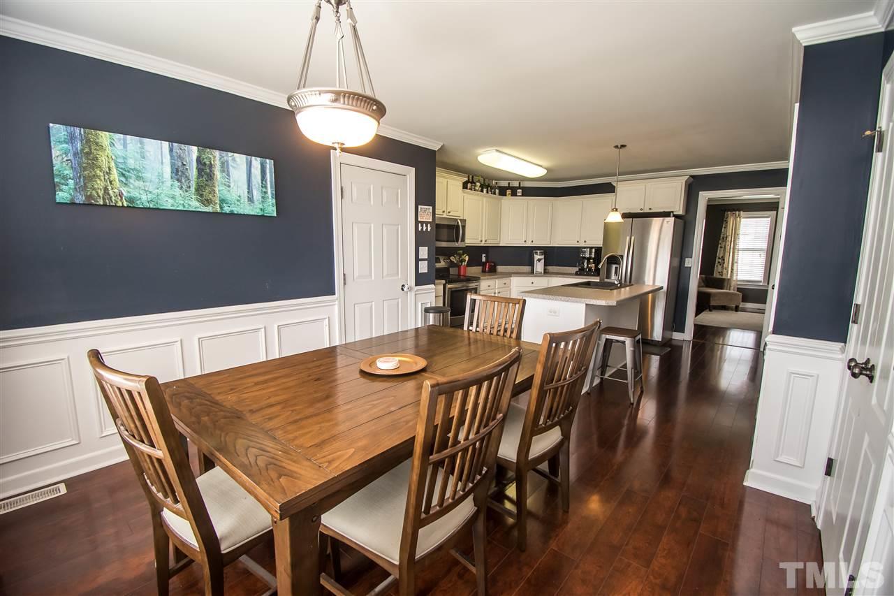 4813 Kure Road Raleigh, NC 27603 - Photo 5 of 25 a view of a dining room with furniture and wooden floor