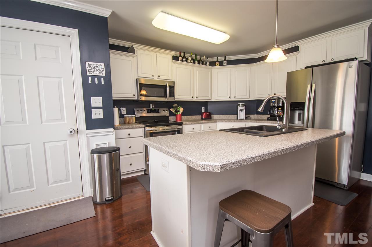 4813 Kure Road Raleigh, NC 27603 - Photo 7 of 25 a kitchen with stainless steel appliances granite countertop a refrigerator stove microwave and sink