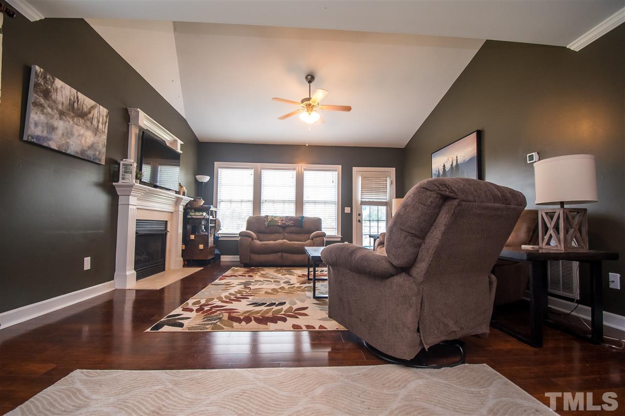 4813 Kure Road Raleigh, NC 27603 - Photo 10 of 25 a living room with furniture and a fireplace