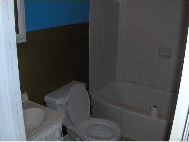 2301 Sheffield Road Raleigh, NC 27610 - Photo 6 of 7 a bathroom with a toilet and a bathtub