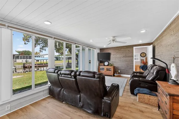 a living room with furniture and a floor to ceiling window