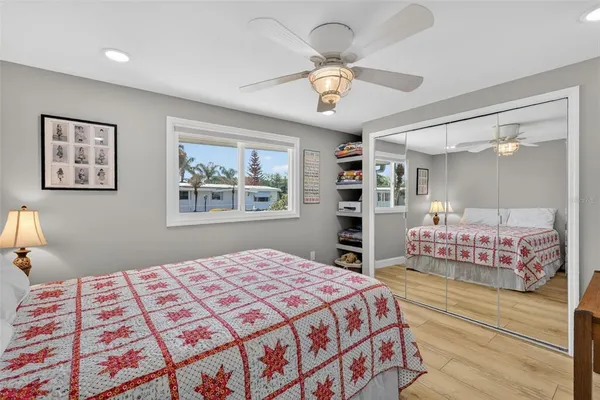 a bedroom with a large bed and a chandelier
