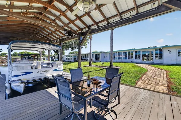 a view of yard from deck with patio
