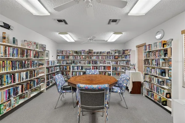 a view of a dining room with furniture and a book shelf