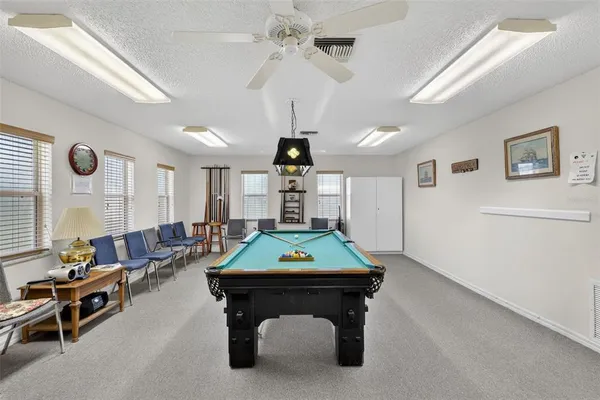 a living room with furniture a rug and a chandelier