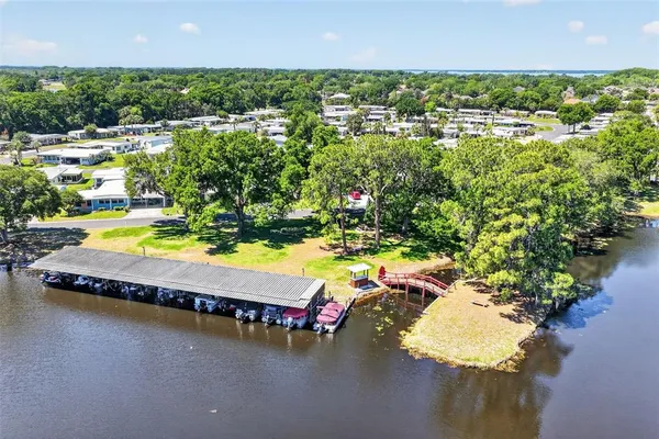an aerial view of a house with a garden and lake view