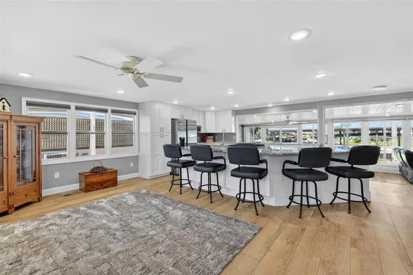 a living room with lots of furniture a window and appliances