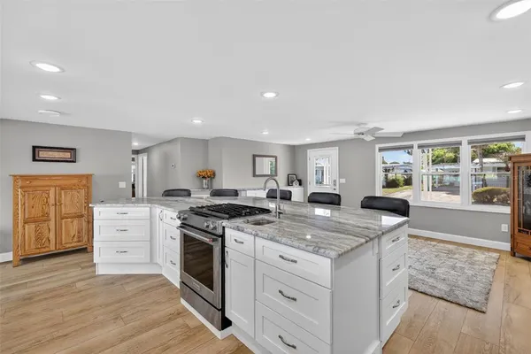 a kitchen with white cabinets and appliances