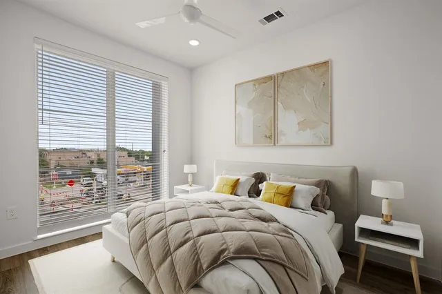 a bedroom with a bed and a window