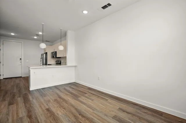 a view of kitchen with wooden floor and window