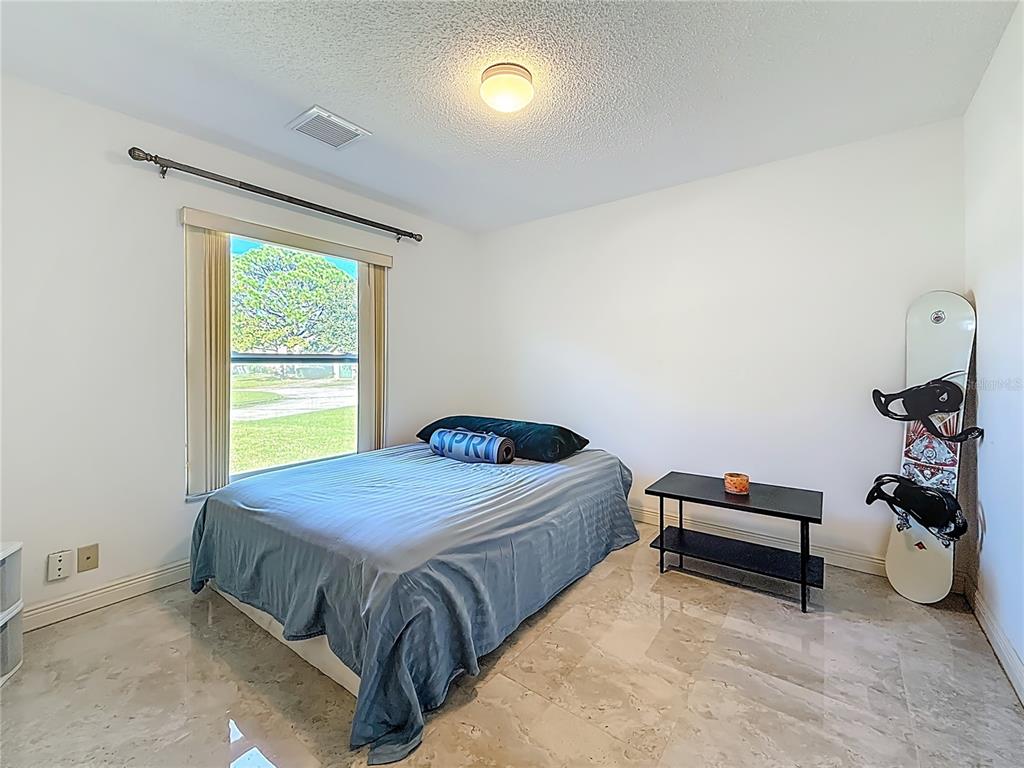 1909 Castle Bay Court Oldsmar, FL 34677 - Photo 11 of 48 a bedroom with a bed and a window