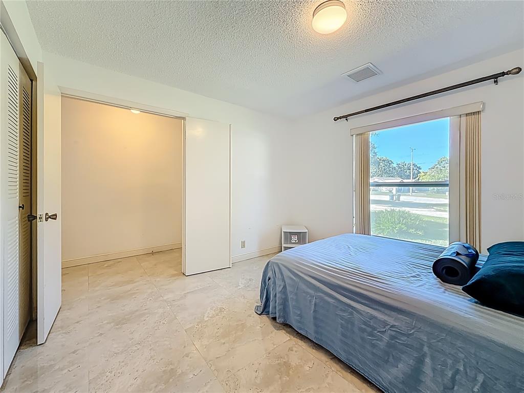 1909 Castle Bay Court Oldsmar, FL 34677 - Photo 12 of 48 a bedroom with a bed and a window