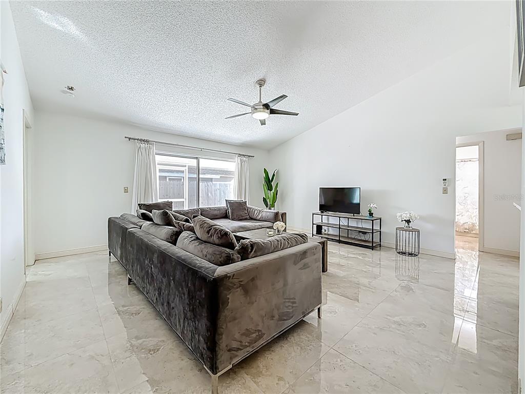1909 Castle Bay Court Oldsmar, FL 34677 - Photo 14 of 48 a living room with furniture and a flat screen tv